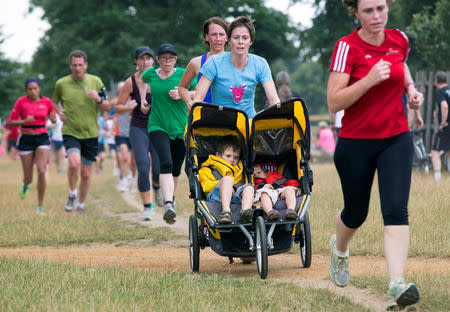 FILE PHOTO: Participants take part in a parkrun event at Bushy Park in London August 2, 2014. REUTERS/Neil Hall/File Photo