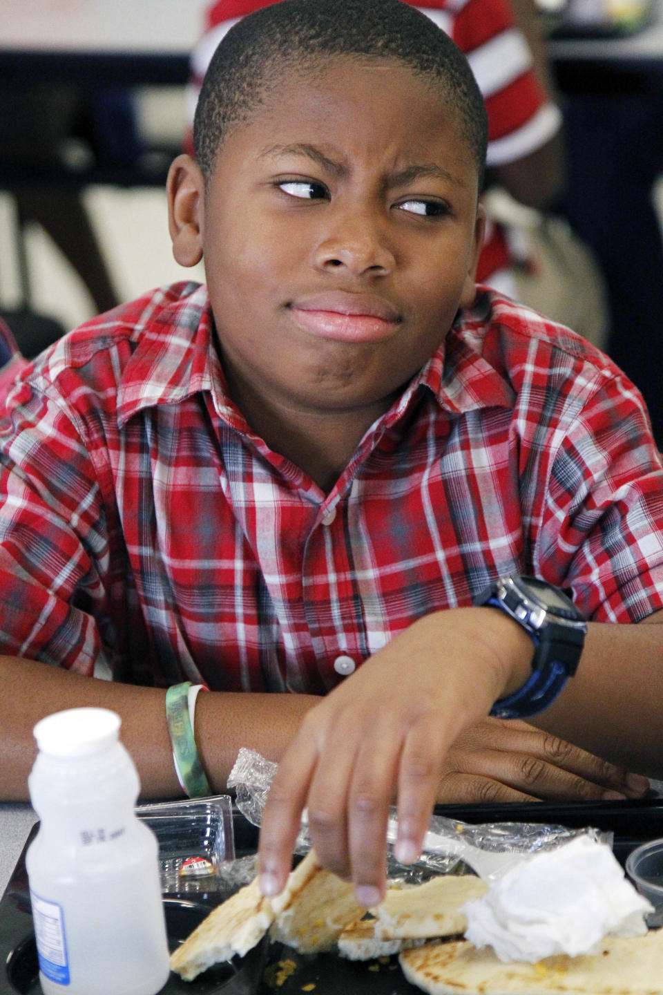 Eastside Elementary fifth grader Kenmari Williams, 10, shows his dislike of the whole wheat flatbread that covered the roast beef sandwich, one of several nutritious lunches available to the children Wednesday, Sept. 12, 2012 at the Clinton, Miss., school. The leaner, greener school lunches served under new federal standards are getting mixed grades from students. (AP Photo/Rogelio V. Solis)