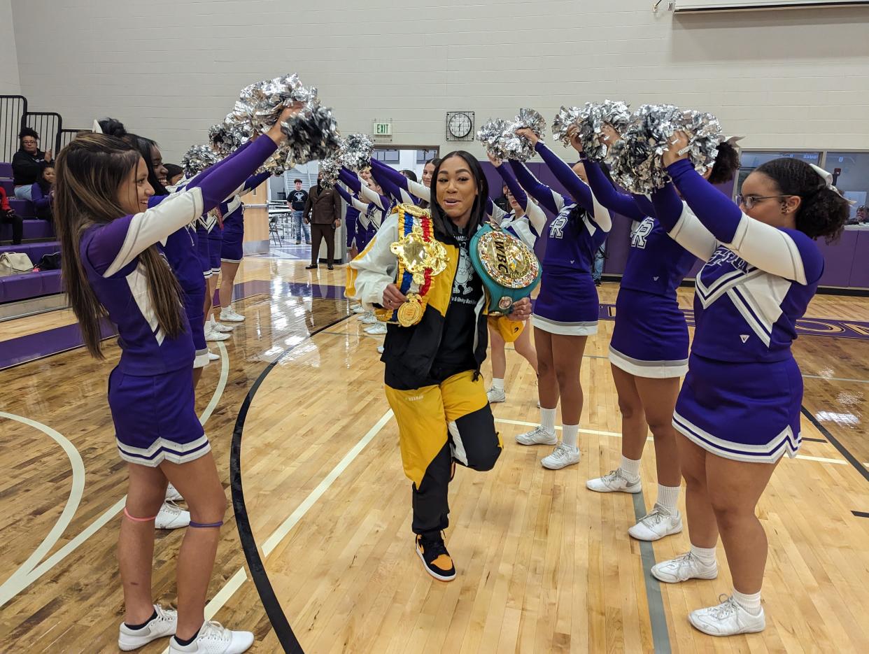 World champion boxer Alycia Baumgardner runs into a basketball rally on Nov. 9, 2023, at Fremont Ross High School, which was also a Thanksgiving turkey give-away she sponsored.