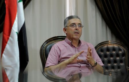 Syria's Minister of National Reconciliation Affairs Ali Haidar gestures as he speaks during an interview with Reuters in his office in Damascus, Syria, July 24, 2017. Picture taken July 24, 2017. REUTERS/ Omar Sanadiki