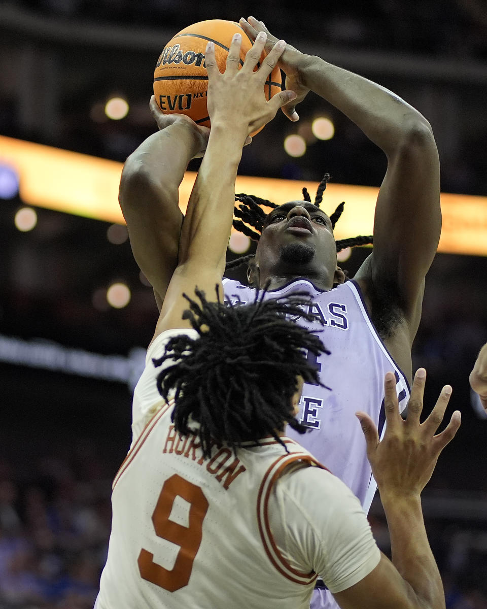 Kansas State forward Arthur Kaluma (24) shoots under pressure from Texas guard Ithiel Horton (9) during the first half of an NCAA college basketball game Wednesday, March 13, 2024, in Kansas City, Mo. (AP Photo/Charlie Riedel)