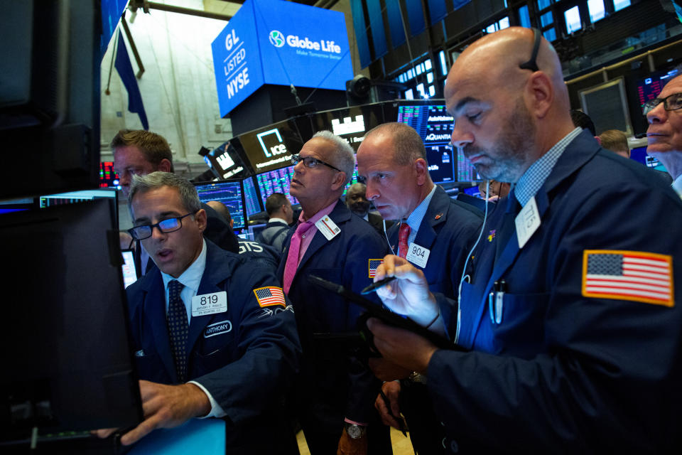 Traders work on the floor at the New York Stock Exchange (NYSE) in New York, U.S., August 12, 2019. REUTERS/Eduardo Munoz