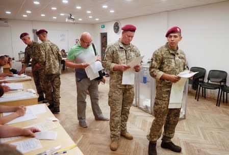 Voters visit a polling station during Ukraine's parliamentary election in Kiev