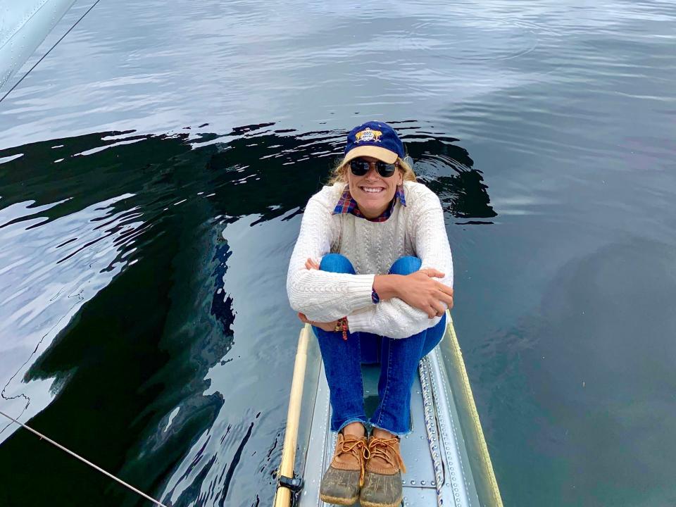 The writing perched on the edge of a boat in Alaska