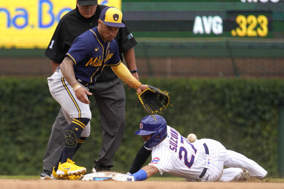 Chicago Cubs' Seiya Suzuki, right, of Japan, steals second base as Milwaukee Brewers second baseman Kolten Wong can't make the catch during the fourth inning of a baseball game in Chicago, Saturday, Aug. 20, 2022. (AP Photo/Nam Y. Huh)