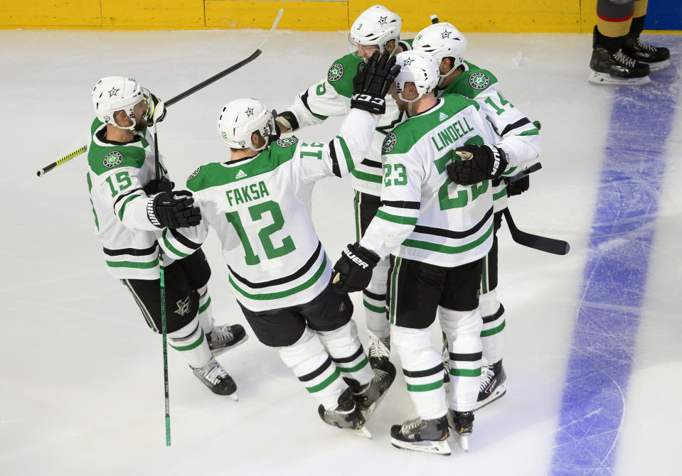 Dallas Stars' Blake Comeau (15), Radek Faksa (12), Esa Lindell (23), Jamie Benn (14) and John Klingberg (3) celebrate a goal by Klingberg against the Vegas Golden Knights during the first period of Game 1 of an NHL Western Conference final hockey game, Sunday, Sept. 6, 2020 in Edmonton, Alberta. (Jason Franson/The Canadian Press via AP)