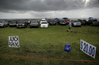 Cars park in a vacant lot in a Titusville, Fla. to watch the launch of SpaceX Falcon 9 with NASA astronauts Doug Hurley and Bob Behnken in the Dragon crew capsule, Wednesday, May 27, 2020 from the Kennedy Space Center at Cape Canaveral, Fla. The two astronauts are set to travel on the SpaceX test flight to the International Space Station. For the first time in nearly a decade, astronauts will travel to space aboard an American rocket from American soil, a first for a private company. (AP Photo/Charlie Riedel)