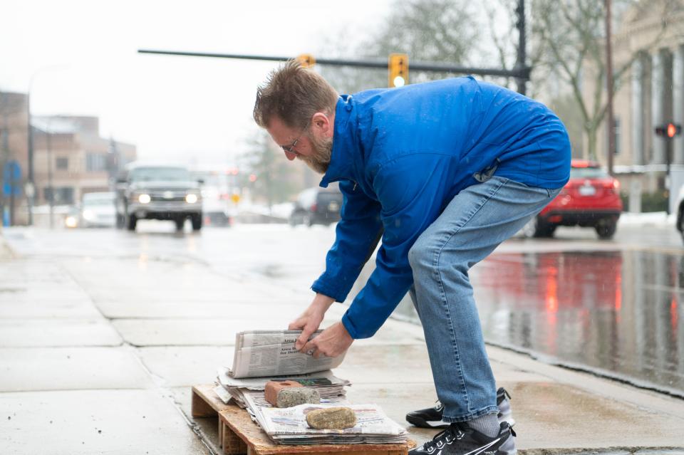 Battle Creek resident Bob Reichel with newspapers for sale on the corner of Capital Avenue and Van Buren Street on Wednesday, Jan. 24, 2024.