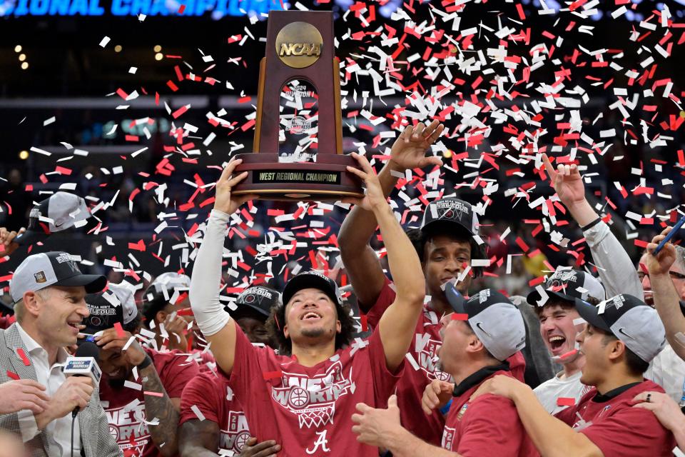 Alabama Crimson Tide guard Mark Sears (1) celebrates with the trophy after defeating the Clemson Tigers in the finals of the West Regional of the 2024 NCAA Tournament at Crypto.com Arena.