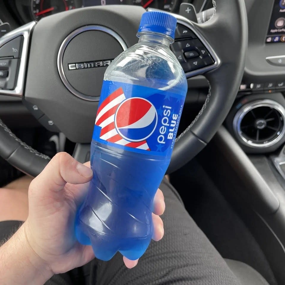 Someone holding a bottle of Pepsi Blue