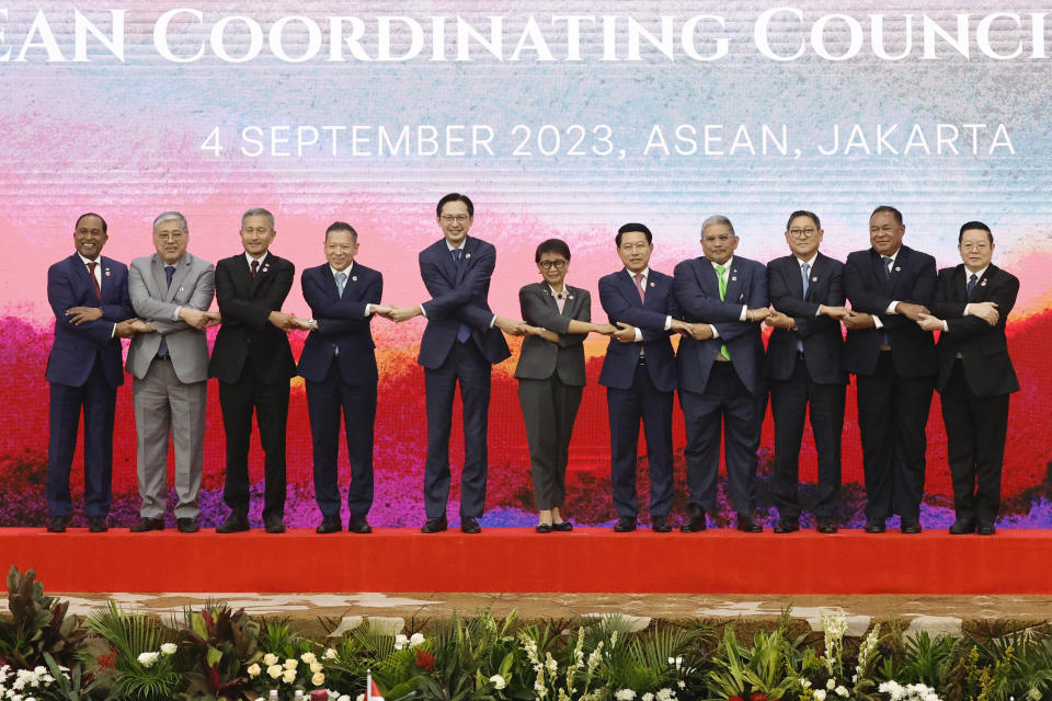 From left, Malaysia's Foreign Minister Zambry Abd Kadir, Philippines' Foreign Secretary Enrique Manalo, Singapore's Foreign Minister Vivian Balakrishnan, Thailand's Permanent Secretary of the Ministry of Foreign Affairs Sarun Charoensuwan, Vietnam's Deputy Foreign Minister Do Hung Viet, Indonesia's Foreign Minister Retno Marsudi, Laos' Foreign Minister Saleumxay Kommasith, Brunei's Foreign Minister Erywan Pehin Yusof, Cambodia's Foreign Minister Sok Chenda Sophea, East Timor's Foreign Minister Bendito dos Santos Freitas, and ASEAN Secretary General Kao Kim Hourn, hold hands for a group photo during the 34th Association of Southeast Asian Nations (ASEAN) Coordinating Council (ACC) meeting, ahead of the ASEAN Summit, at the ASEAN Secretariat in Jakarta, Indonesia, Monday, Sept. 4, 2023. (Willy Kurniawan/Pool Photo via AP)