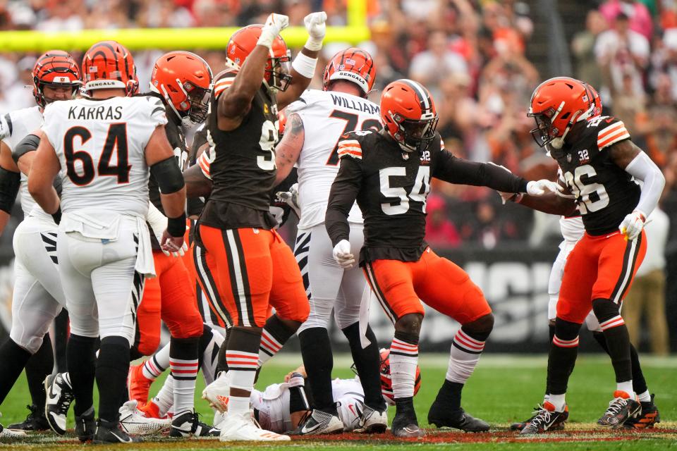 Cleveland Browns defensive end Ogbo Okoronkwo (54) celebrates a sack of Cincinnati Bengals quarterback Joe Burrow (9) in the first quarter of an NFL football game between the Cincinnati Bengals and Cleveland Browns, Sunday, Sept. 10, 2023, at Cleveland Browns Stadium in Cincinnati.