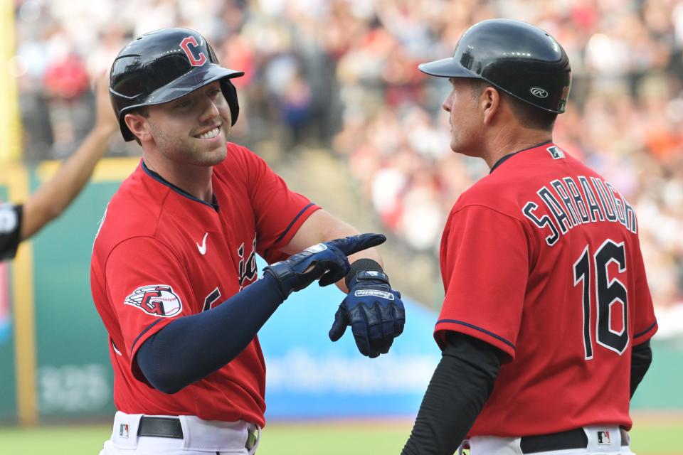 Guardians first baseman Owen Miller (left) celebrates after hitting an RBI triple during the first inning July 15, 2022 against the Tigers at Progressive Field in Cleveland.