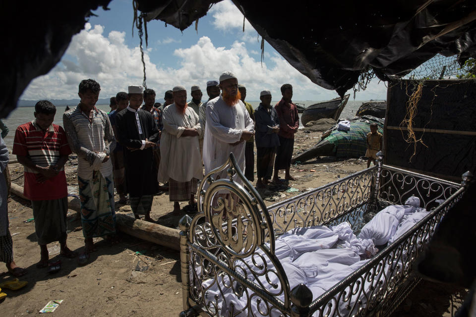 <p>A funeral takes place for five children after an overcrowded boat carrying Rohingya fleeing Myanmar capsized overnight killed around 12 people including five children on October 9, on Shah Porir Dwip Island, Cox’s Bazar, Bangladesh. Around 35 people were on the boat and eight survived. Well over a half a million Rohingya refugees have fled into Bangladesh since late August during the outbreak of violence in Rakhine state causing a humanitarian crisis in the region with continued challenges for aid agencies. (Photograph by Paula Bronstein/Getty Images) </p>