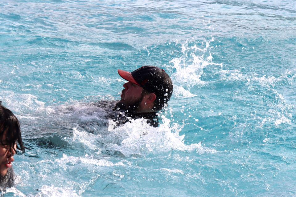 Justin Hoopes does the backstroke for part of the distance across the cold water in the annual Special Olympics Polar Plunge held at Amarillo Town Club on Hillside Saturday morning.