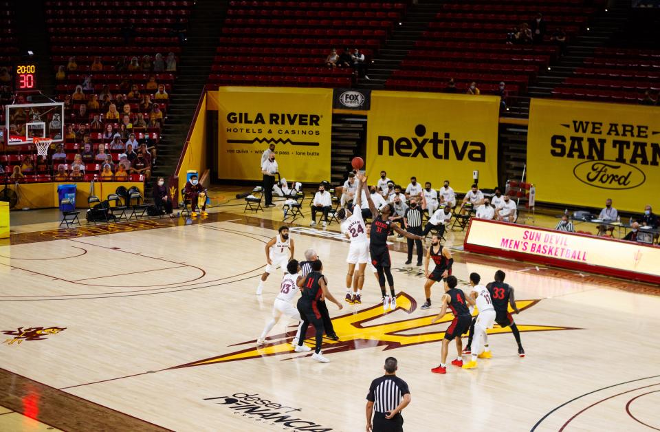 Arizona State Sun Devils forward Jalen Graham (24) jumps for the opening tipoff against San Diego State Aztecs forward Nathan Mensah (31) to begin the game at Desert Financial Arena in Tempe on Dec. 10, 2020.