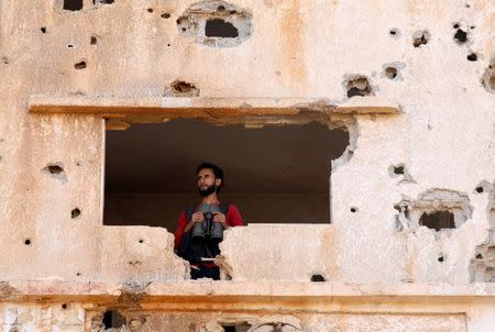 A fighter from the Free Syrian Army is seen in Yadouda area in Deraa, Syria May 29, 2018. REUTERS/Alaa Al-Faqir/Files