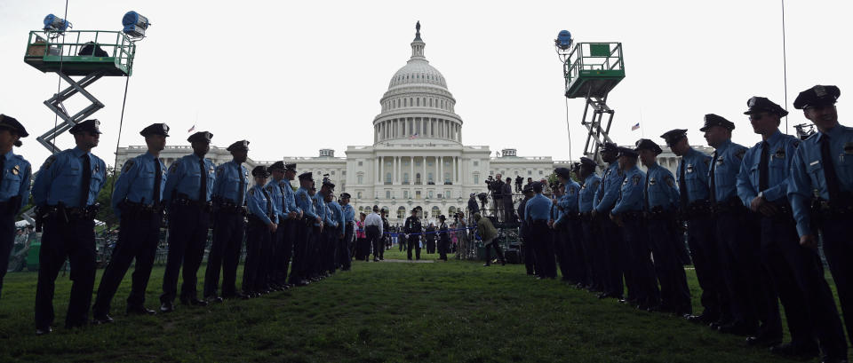 Law enforcement officers line up on the lawn on the east side of the U.S. Capitol during the 32nd annual National Peace Officers' Memorial Service at the U.S. Capitol May 15, 2013 in Washington, D.C. (Photo by Chip Somodevilla/Getty Images)