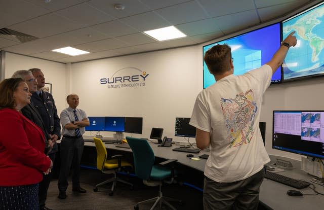 Personnel from UK Space Command and Defence Equipment and Support being briefed about the processes of the UK Space Command satellite launch