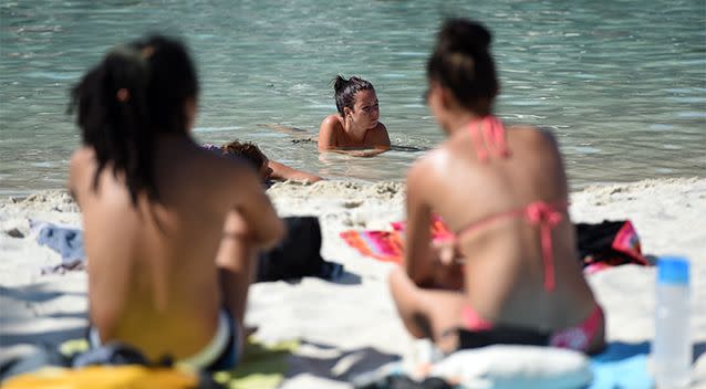 Beachgoers soak up the sun in Brisbane. Photo: AAP