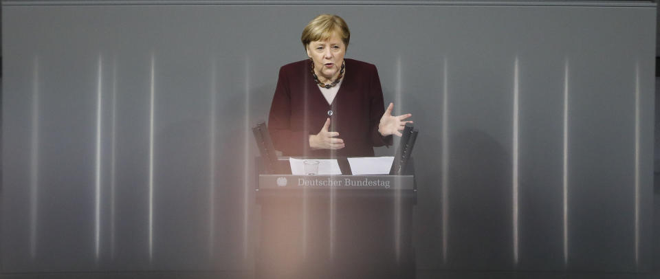 German Chancellor Angela Merkel delivers a speech about German government's policies to combat the spread of the coronavirus and COVID-19 disease at the parliament Bundestag, in Berlin, Germany, Thursday, Nov. 26, 2020. Merkel and the country's 16 state governors have agreed to extend a partial shutdown well into December in an effort to further reduce the rate of coronavirus infections ahead of the Christmas period. (AP Photo/Markus Schreiber)