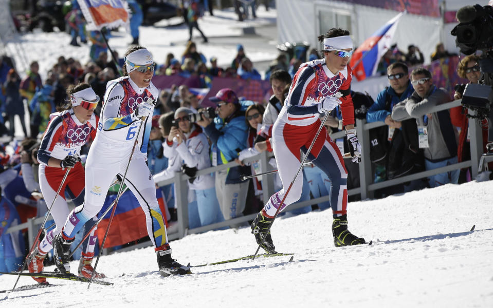 Norway's gold medal winner Marit Bjoergen, right, and Sweden's silver medal winner Charlotte Kalla climb a hill during the women's cross-country 15k skiathlon at the 2014 Winter Olympics, Saturday, Feb. 8, 2014, in Krasnaya Polyana, Russia. (AP Photo/Lee Jin-man)
