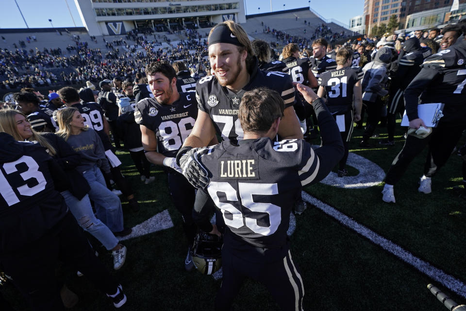 Vanderbilt players celebrate after their 31-24 win over Florida in an NCAA college football game Saturday, Nov. 19, 2022, in Nashville, Tenn. (AP Photo/Mark Humphrey)