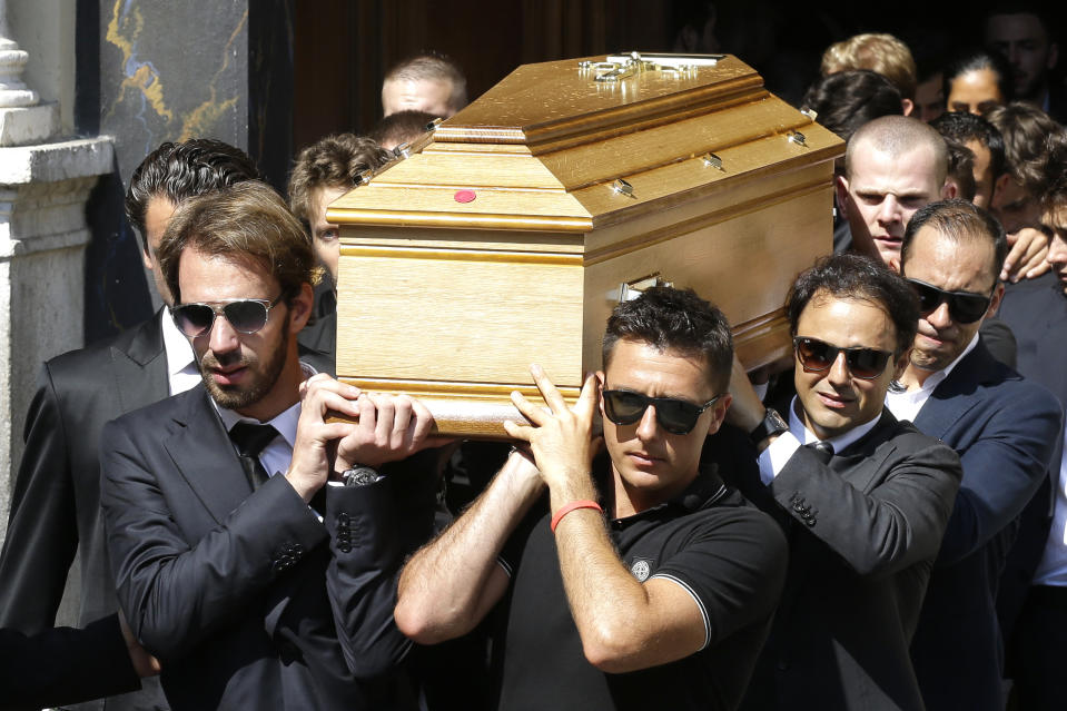 French Formula One driver Jean Eric Vergne, left, Brazilian Formula One driver Felipe Massa, second right, and Venezuelan Formula One driver Pastor Maldonado, right, carry the casket of French Formula One driver Jules Bianchi into Sainte Reparate Cathedral during his funeral in Nice, French Riviera, Tuesday, July 21, 2015. Bianchi, 25, died Friday from head injuries sustained in a crash at last year's Japanese Grand Prix. He had been in a coma since the Oct. 5 accident, in which he collided at high speed with a mobile crane which was being used to pick up another crashed car. (AP Photo/Lionel Cironneau)