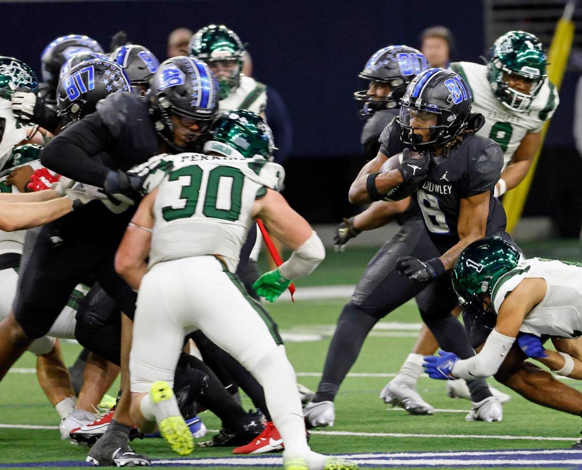 North Crowley running back Ashton Searl (8) runs into traffic in the second half of a UIL Class 6A Division 1 football regional-round playoff game at The Ford Center in Frisco, Texas, Saturday, Oct. 25, 2023.