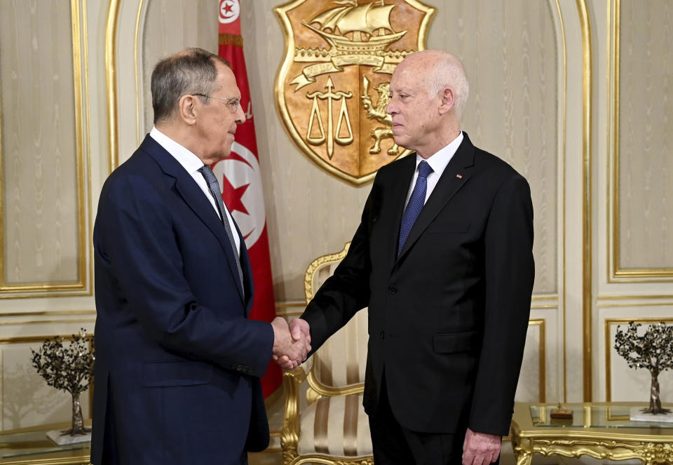 This photo provided by the Tunisia presidency shows Tunisian President Kais Saied, right, shaking hands with Russian Foreign Minister Sergey Lavrov, Thursday Dec. 21, 2023 in Tunis. Russia is working to deepen political and economic ties and spread its narrative about wars in Ukraine and Gaza. (Slim Abid/Tunisian Presidency via AP)