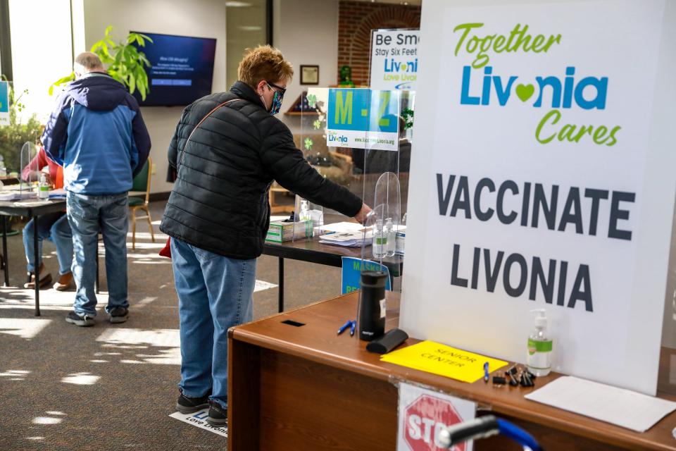 Ann Schmoekel, 66, of Livonia, a retired nuclear medicine technologist, waits to check in as the Livonia Fire Department, in coordination with the city of Livonia, administers the Pfizer COVID-19 vaccine at the Livonia Park Senior Center in Livonia, Mich. on Friday, Feb. 26, 2021.