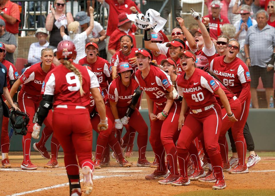 Oklahoma celebrates the game-tying, three-run homer by Kinzie Hansen (9) in the seventh inning of Saturdays' NCAA super regional against Clemson.