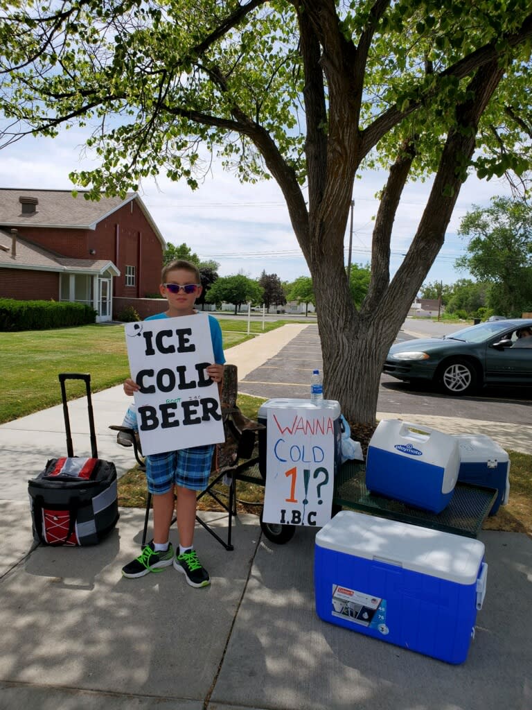 Seth poses with his bold signs at his root beer stand in Brigham City, Utah. (Credit: Alexis) 