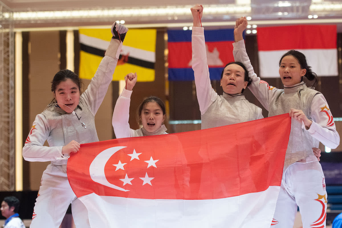 The Singapore women's foil fencing team of (from left) Maxine Wong, Tay Yu Ling, Tiffany Seet and Cheung Kemei celebrate winning the gold medal at the 2023 SEA Games. (PHOTO: SNOC/Lim Weixiang)