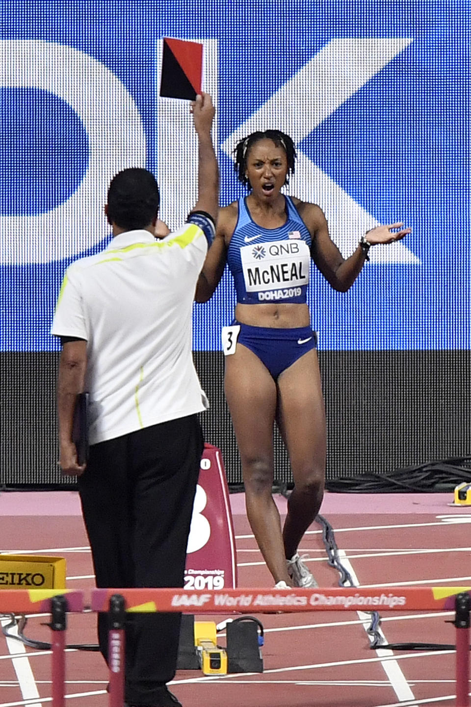 Brianna Mcneal, of the United States, is disqualified after a false start in the women's 100 meter hurdles heats during the World Athletics Championships in Doha, Qatar, Saturday, Oct. 5, 2019. (AP Photo/Martin Meissner)