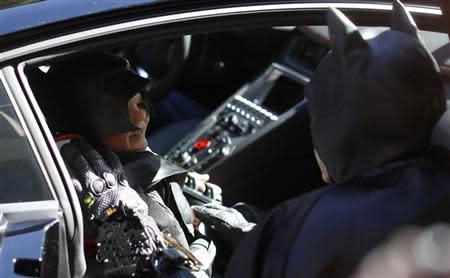 Five-year-old leukemia survivor Miles Scott, dressed as "Batkid" speaks to Batman as he sits in the Batmobile as part of a day arranged by the Make- A - Wish Foundation in San Francisco, California November 15, 2013. REUTERS/Stephen Lam