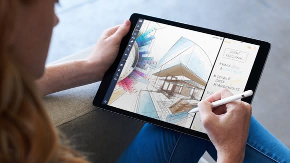 A person drawing on an iPad Pro with an Apple Pencil