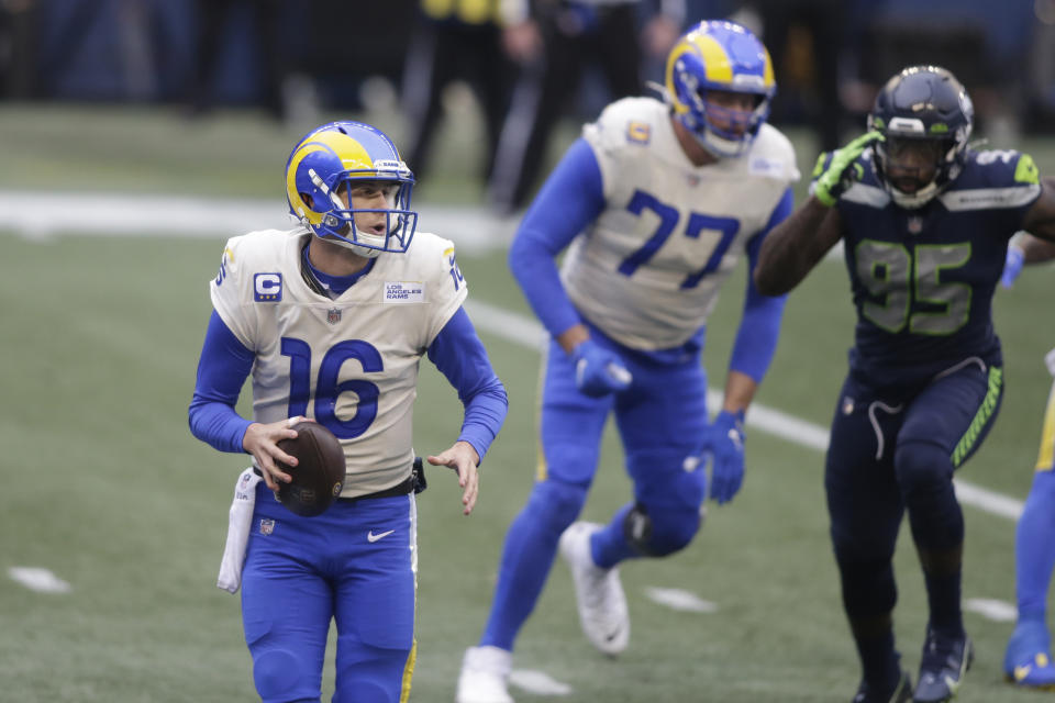 Los Angeles Rams quarterback Jared Goff (16) scrambles as he looks for room to pass against the Seattle Seahawks during the first half of an NFL wild-card playoff football game, Saturday, Jan. 9, 2021, in Seattle. (AP Photo/Scott Eklund)