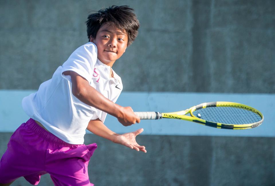 South's Caleb Lian makes a return in his match during the North versus South boys tennis match at Bloomington High School North on Tuesday, September 10, 2024.