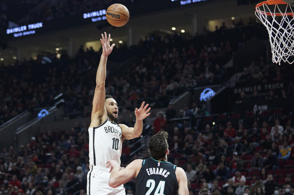 Brooklyn Nets guard Ben Simmons, left, shoots over Portland Trail Blazers forward Drew Eubanks during the first half of an NBA basketball game in Portland, Ore., Thursday, Nov. 17, 2022. (AP Photo/Craig Mitchelldyer)