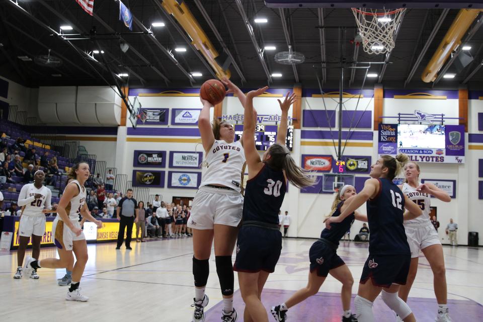 Kansas Wesleyan's Kelcey Hinz (1) puts a shot up over Sterling's Bethany Stucky (30) during Thursday's game at Mabee Arena.