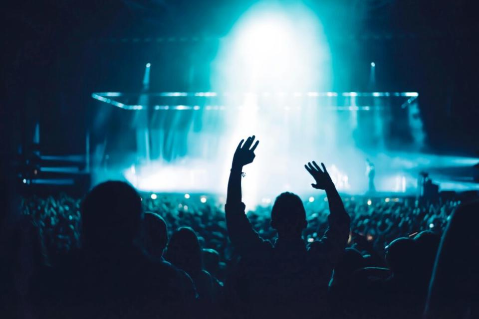 fans with hands lifted at music festival