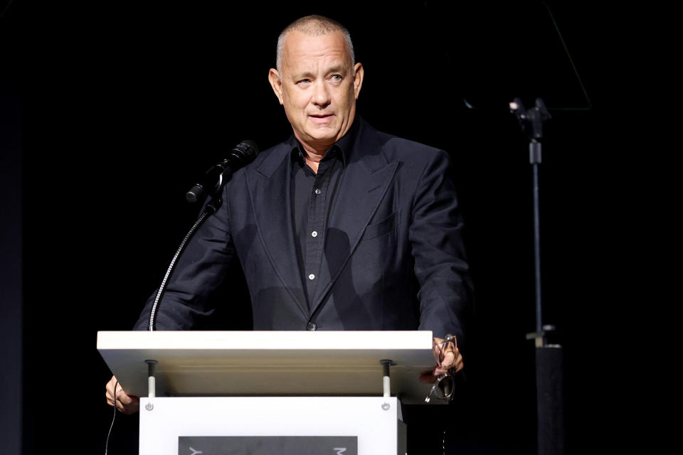 <p>Tom Hanks mans the podium on Sept. 21 at the opening of the Academy Museum of Motion Pictures in Los Angeles. </p>