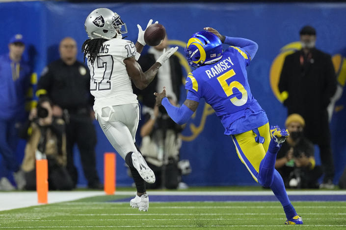 Las Vegas Raiders wide receiver Davante Adams, left, makes a catch as Los Angeles Rams cornerback Jalen Ramsey defends during the first half of an NFL football game Thursday, Dec. 8, 2022, in Inglewood, Calif. (AP Photo/Mark J. Terrill)