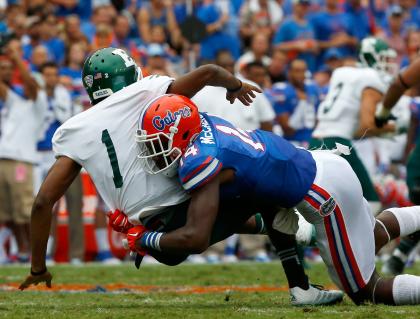 GAINESVILLE, FL - SEPTEMBER 06: Rob Bolden #1 of the Eastern Michigan Eagles is sacked by Alex McCalister #14 of the Florida Gators during the game at Ben Hill Stadium on September 6, 2014 in Gainesville, Florida. (Photo by Sam Greenwood/Getty Images)