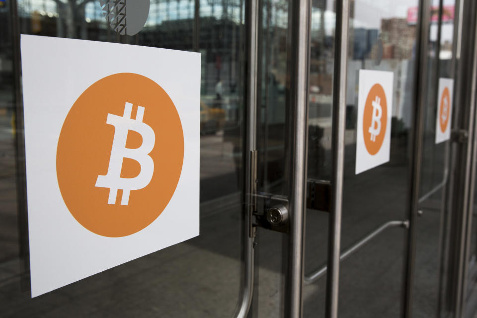 Bitcoin themed stickers stand attached to glass doors during the Inside Bitcoins: The Future of Virtual Currency Conference in New York April 8, 2014. REUTERS/Lucas Jackson (UNITED STATES - Tags: BUSINESS SCIENCE TECHNOLOGY)