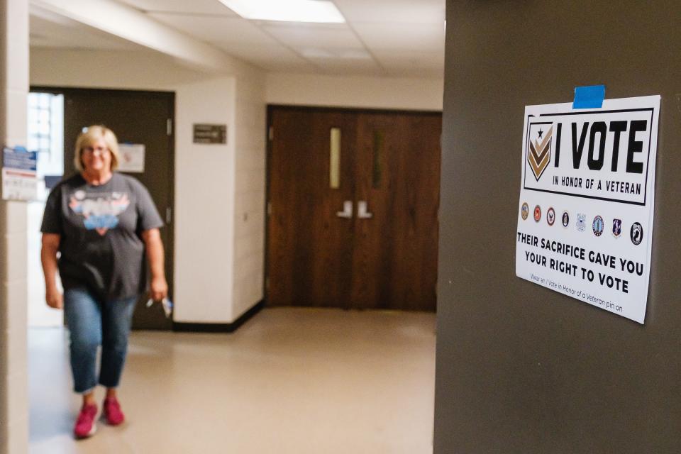 A woman departs the polls after casting her vote on Issue 1, Tuesday, Aug. 8, at Dover Alliance Church.