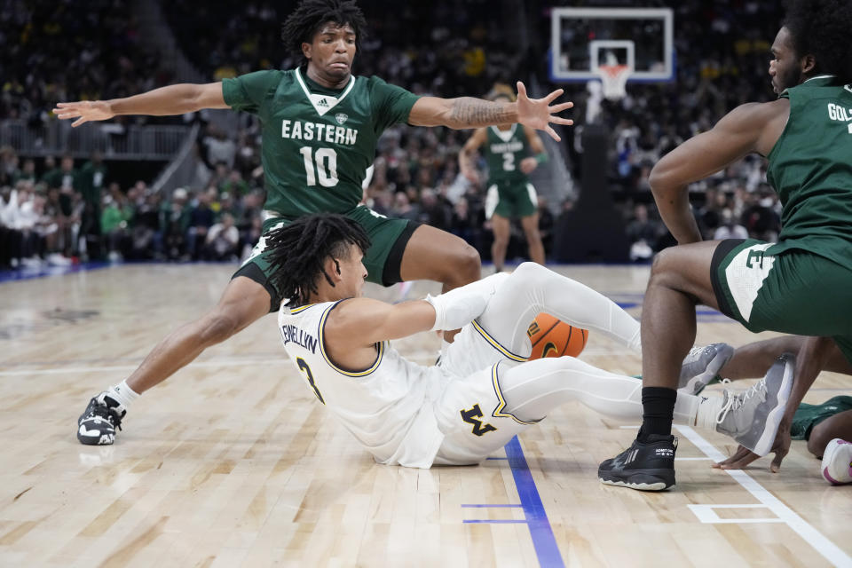 Michigan guard Jaelin Llewellyn (3) loses control of the ball next to Eastern Michigan guard Orlando Lovejoy (10) during the first half of an NCAA college basketball game, Friday, Nov. 11, 2022, in Detroit. (AP Photo/Carlos Osorio)