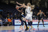 Chicago Sky center Candace Parker, left, goes to the basket against Dallas Wings center Bella Alarie (32) during the first half in the first round of the WNBA basketball playoffs, Thursday, Sept. 23, 2021, in Chicago. (AP Photo/Kamil Krzaczynski)