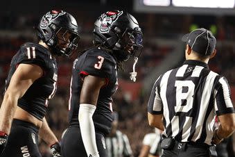 North Carolina State's Aydan White (3) and Payton Wilson (11) talk with an official during the second half of the team's NCAA college football game against Louisville in Raleigh, N.C., Friday, Sept. 29, 2023. (AP Photo/Karl B DeBlaker)